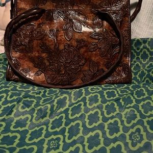 A beautiful shining bag with leaves . Clean inside and out, no signs of use,